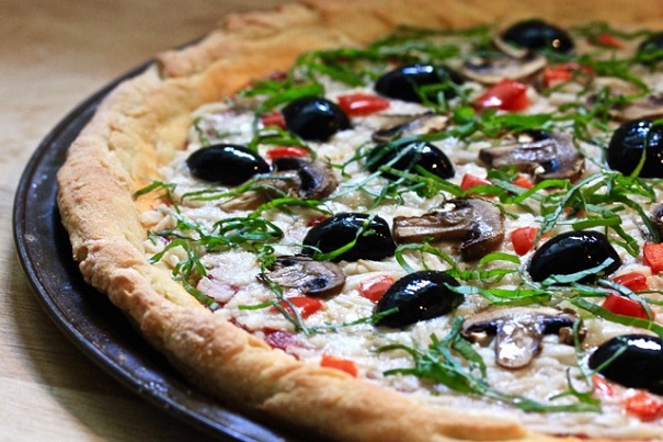 Olives, basil, mozzarella cheese on a gluten free crust